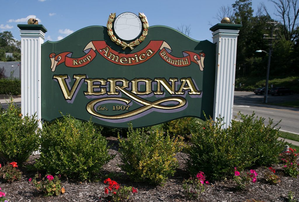 photo shows a sign that says 'verona' in carved and painted lettering