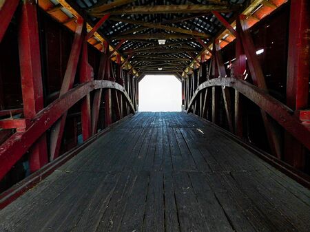 photo shows the inside of the bridge. it is dark with old wood