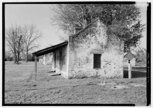 Magnolia Plantation. photo shows a black and white image of a tiny brick cabin