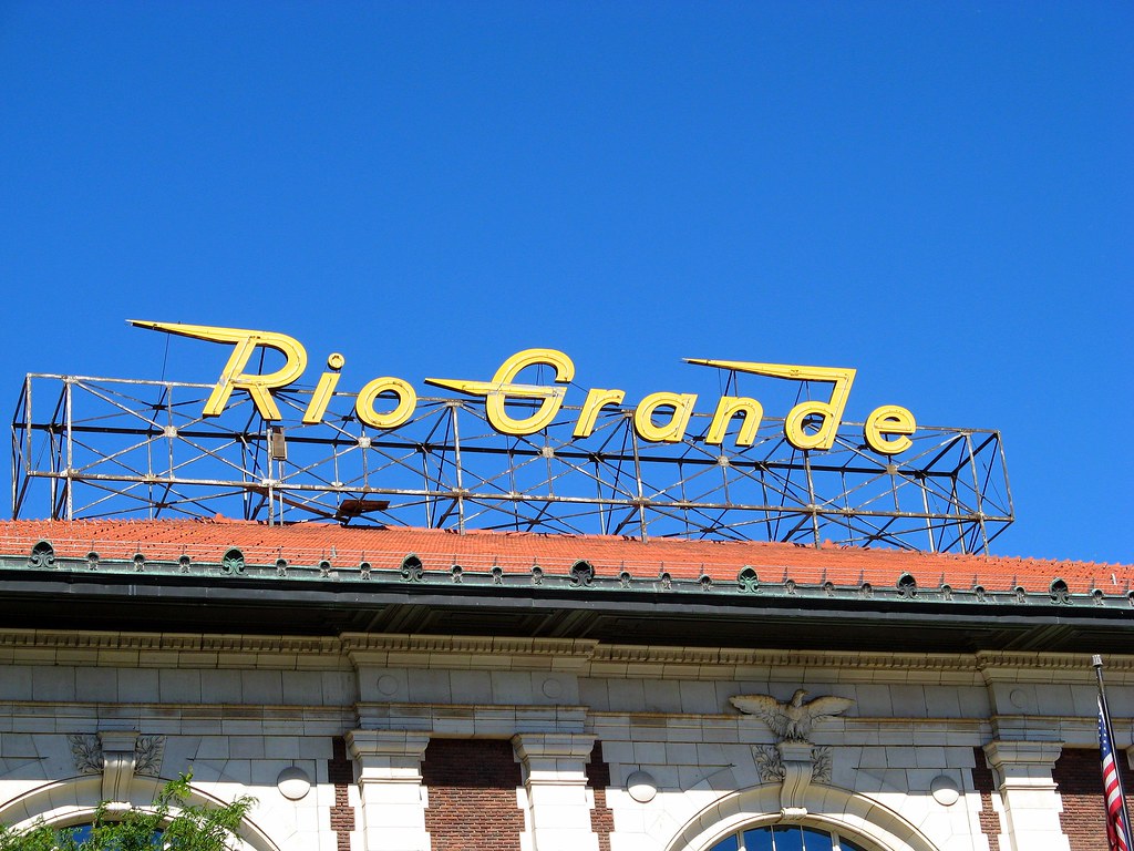 A large yellow sign atop a building that reads Rio Grande in Salt Lake City. 