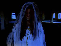 Photo of a girl with hair in front of her face. She is dressed in a white dress. 